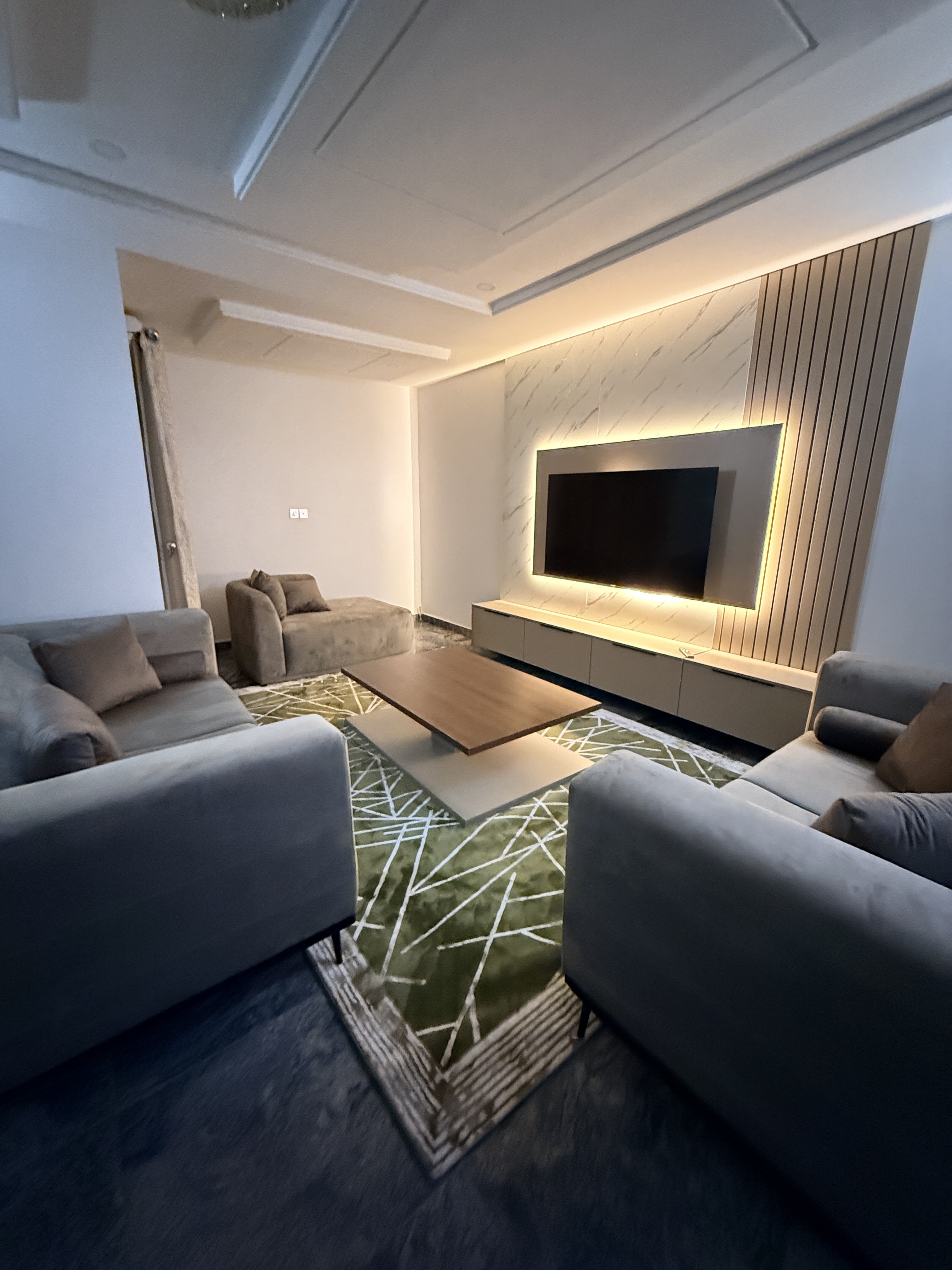 Modern living room with illuminated media wall